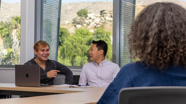 Professors Meeting in the New Business Building Conference Room